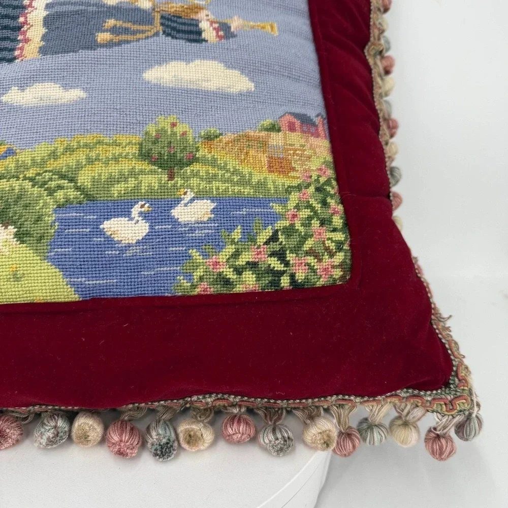 Needlepoint pillow featuring a folk art angel motif dark red velvet background